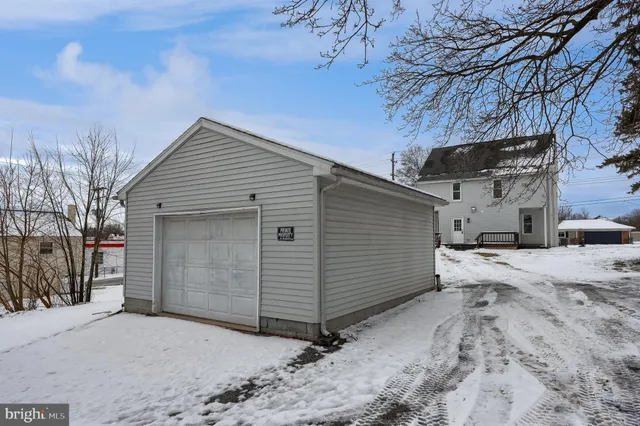 a view of a house with a snow in the yard