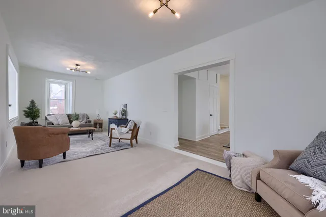 a living room with furniture and a chandelier