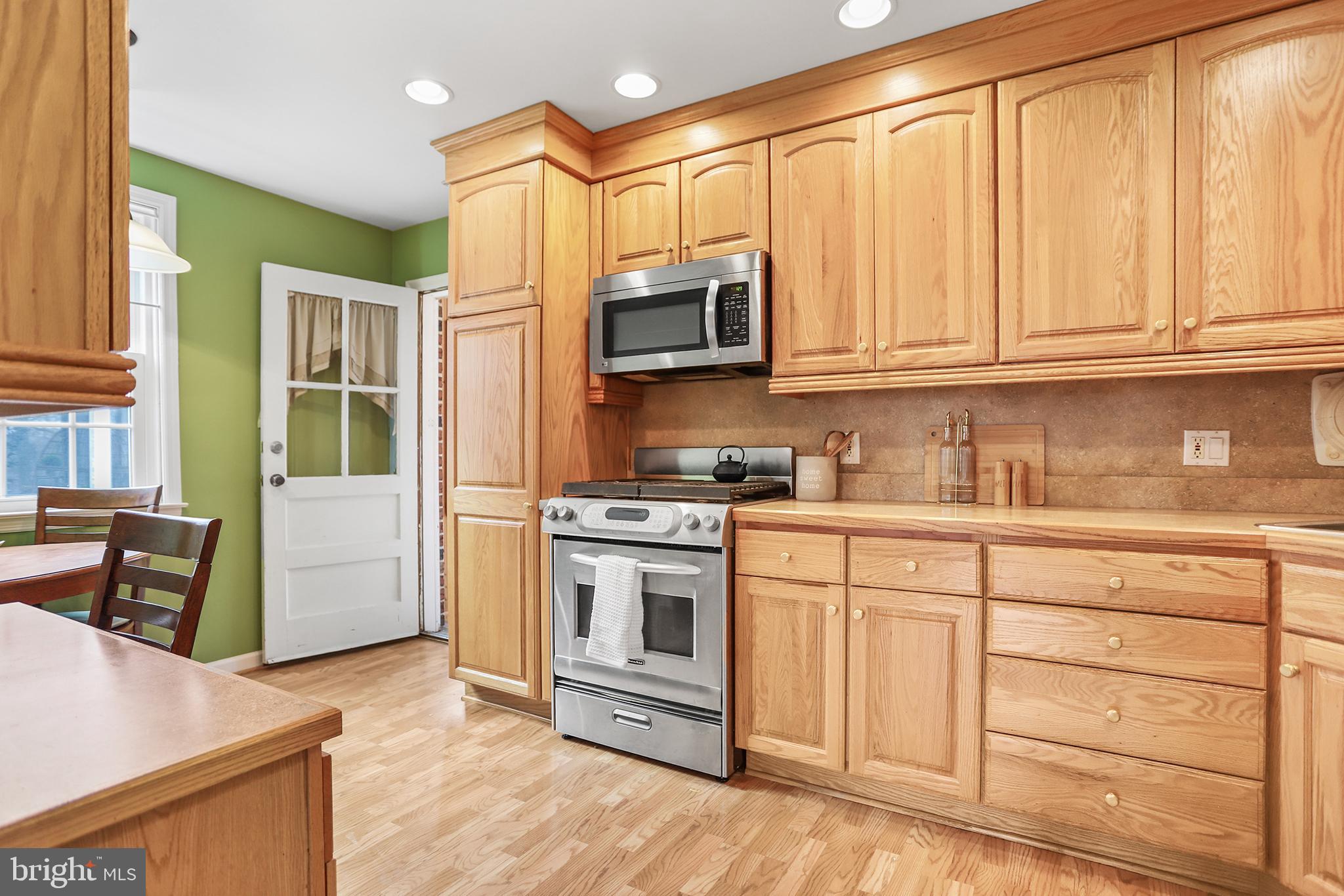 317 East Rodgers Street Ridley Park, PA 19078 - Photo 9 of 24 a kitchen with granite countertop white cabinets and stainless steel appliances