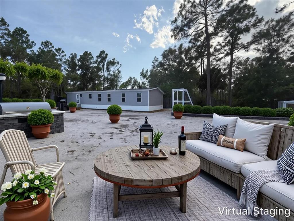 114 Nutmeg Trail Interlachen, FL 32148 - Photo 29 of 33 a view of a patio with couches table and chairs potted plants with wooden fence