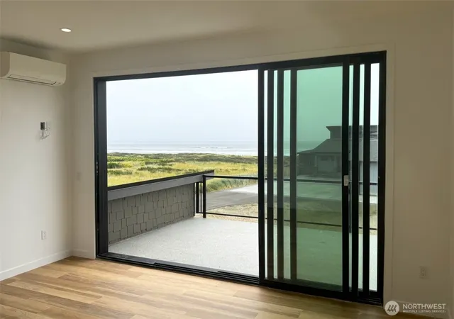 a big room with wooden floor and windows