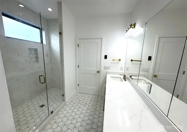 a spacious bathroom with a granite countertop sink a toilet mirror and bathtub