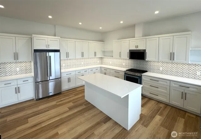 an empty room with large windows