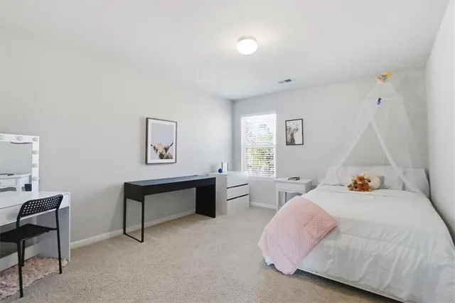 a bedroom with a bed and a ceiling fan