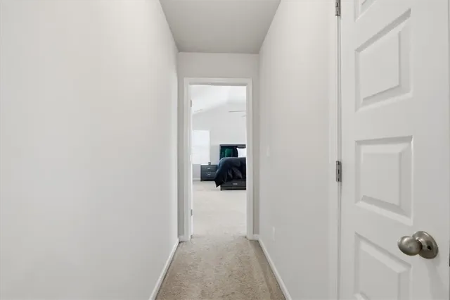 a view of a room with wooden floor and a hallway