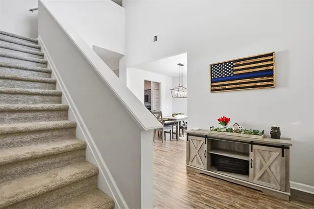 a view of a dining room with furniture wooden floor and chandelier
