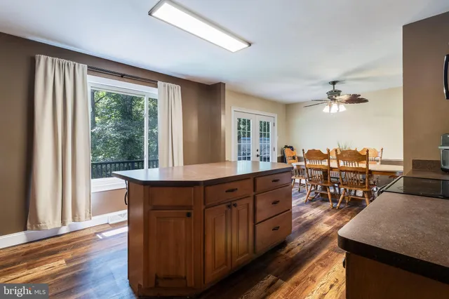 a kitchen with wooden cabinets and wooden floors