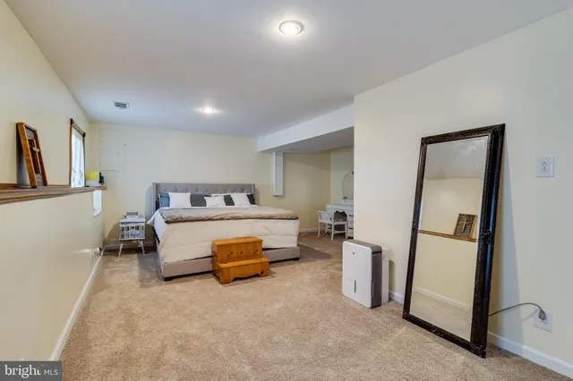 a bedroom with bed and window