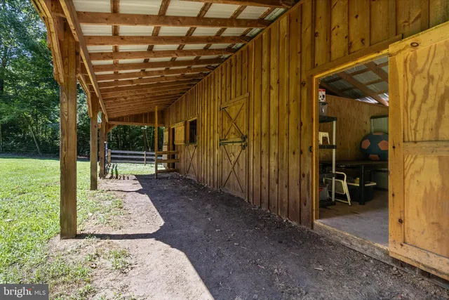 a view of a porch with a table and chairs