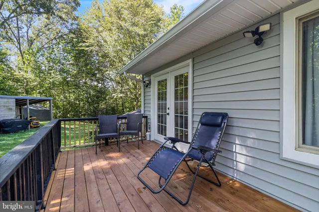 a view of balcony with chairs and a barbeque
