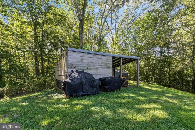 a backyard of a house with barbeque oven