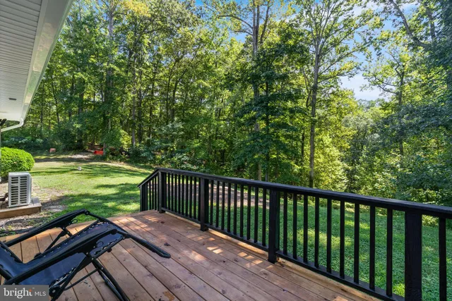 a balcony with wooden floor and outdoor space
