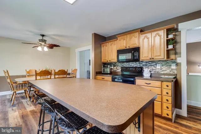 a view of kitchen with cabinets and wooden floor