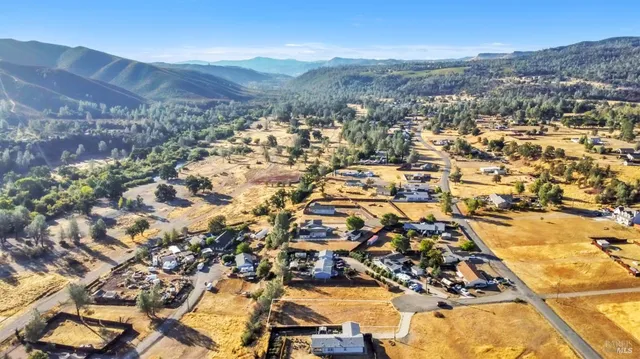 an aerial view of residential houses with outdoor space