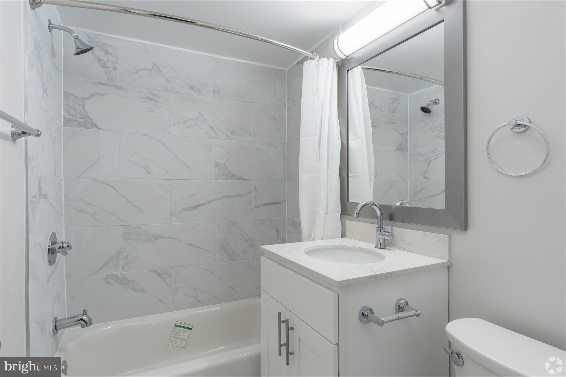 8440 Limekiln Pike, Unit 2BR Wyncote, PA 19095 - Photo 3 of 11 a bathroom with a sink mirror vanity and toilet
