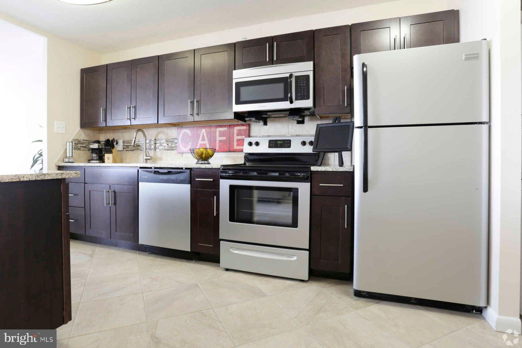 8440 Limekiln Pike, Unit 2BR Wyncote, PA 19095 - Photo 4 of 11 a kitchen with a refrigerator stove and microwave