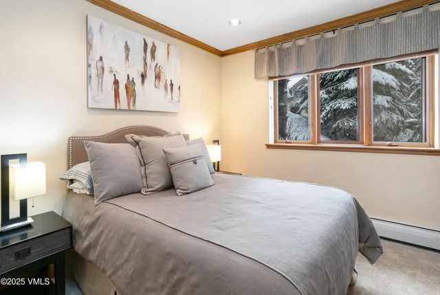 a bedroom with a large bed and a window