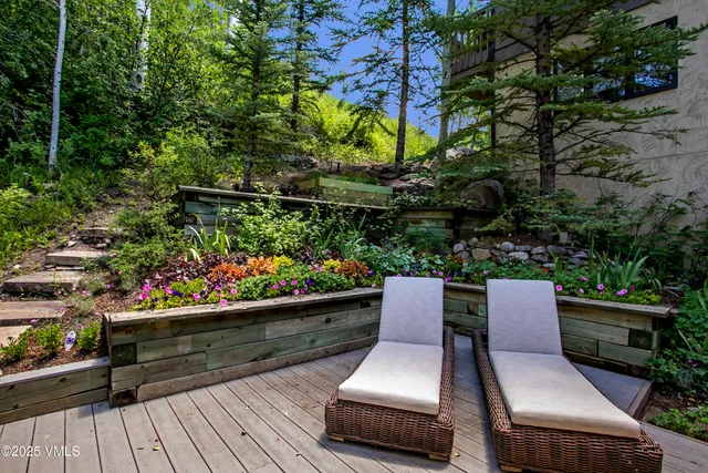 a view of backyard with seating and trees