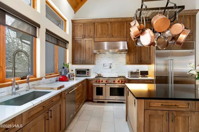 a kitchen with a sink stove and cabinets