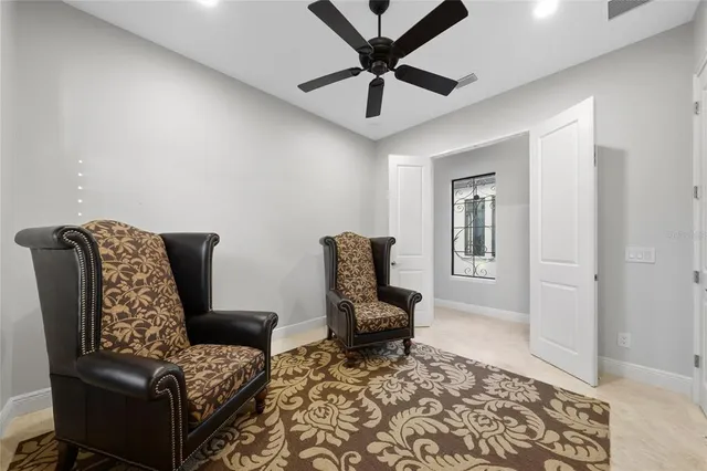 an aerial view of ocean and residential houses with outdoor space