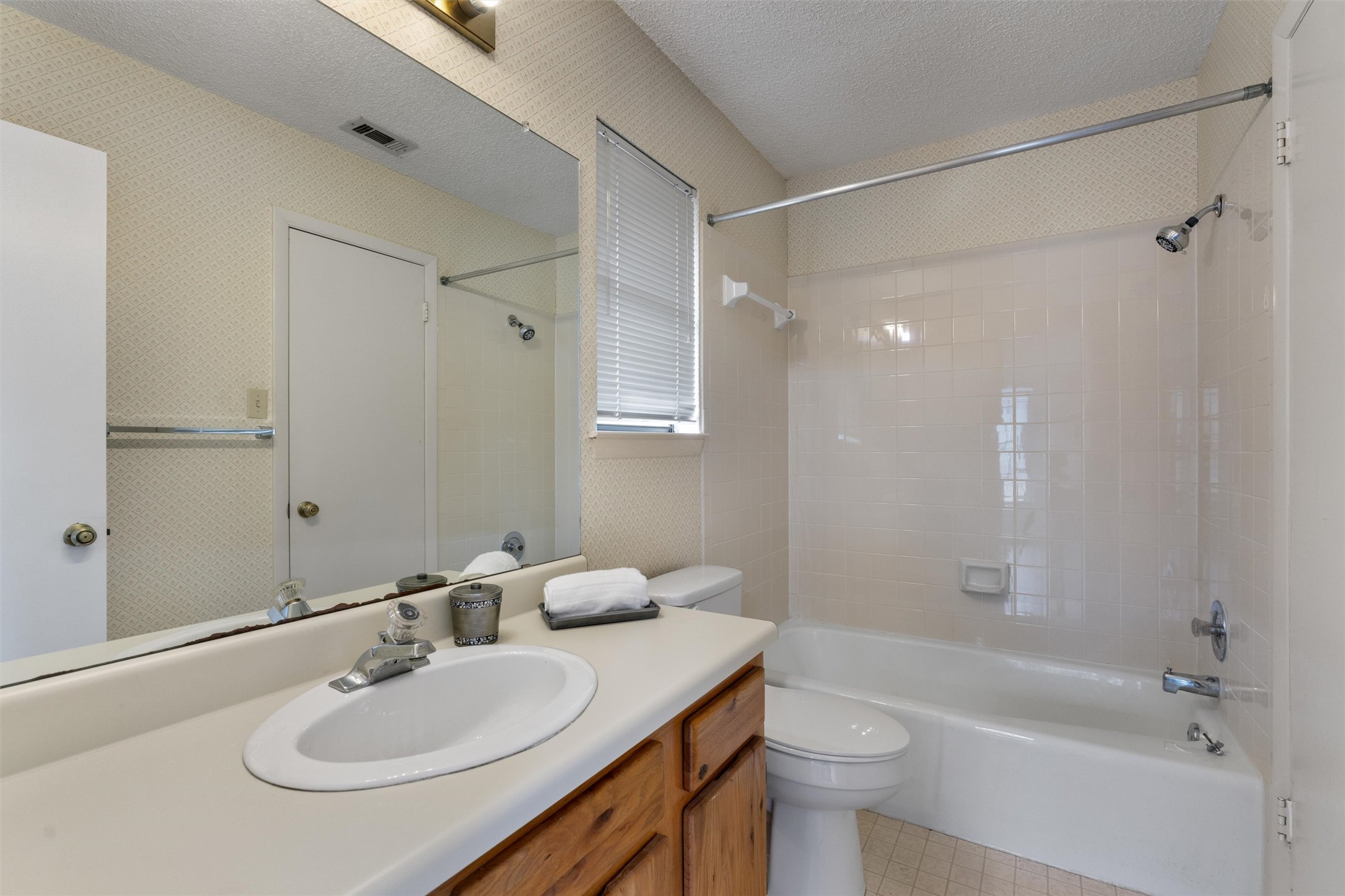 12314 Furrow Cove, Unit A Austin, TX 78753 - Photo 17 of 23 Bathroom featuring vanity, a textured ceiling, and shower / tub combination
