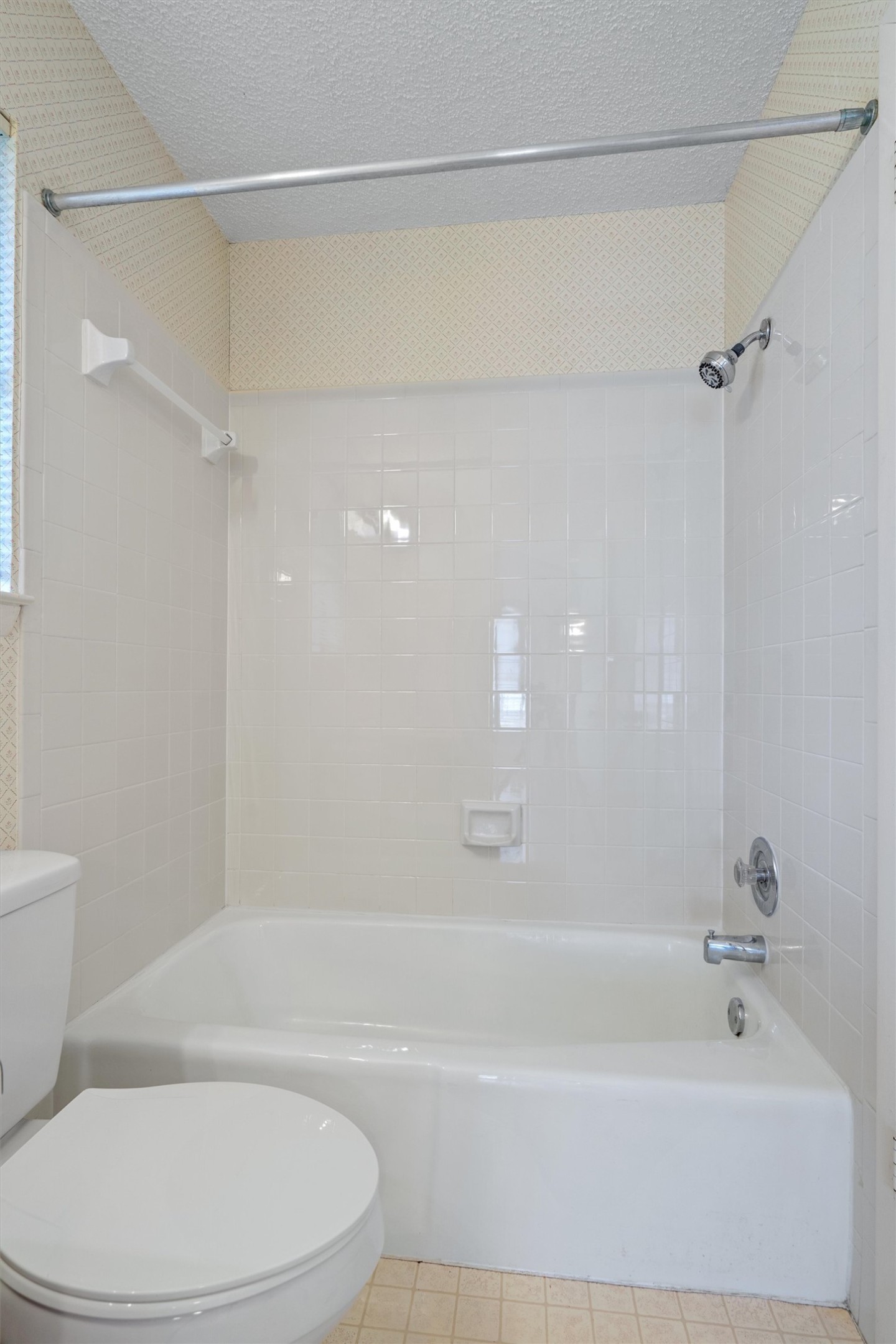 12314 Furrow Cove, Unit A Austin, TX 78753 - Photo 18 of 23 Full bath featuring shower / washtub combination, a textured ceiling, and tile patterned floors