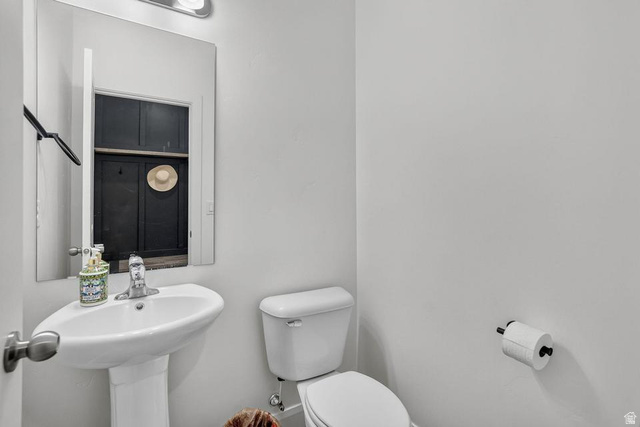 5898 Jasper Rdg Drive St. George, UT 84790 - Photo 13 of 41 Clean and functional half bath featuring a pedestal sink with chrome faucet, white ceramic toilet, and neutral wall finishes