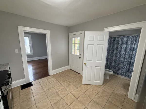 a view of empty room with wooden floor