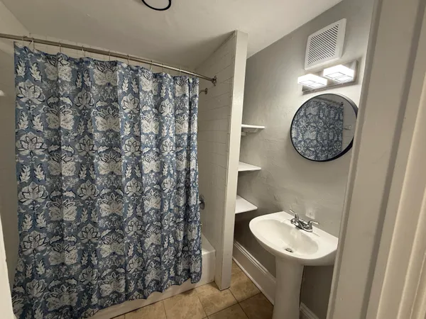 a bathroom with a sink toilet and mirror