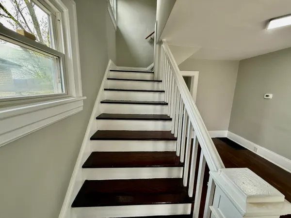 a view of entryway and hall with wooden floor