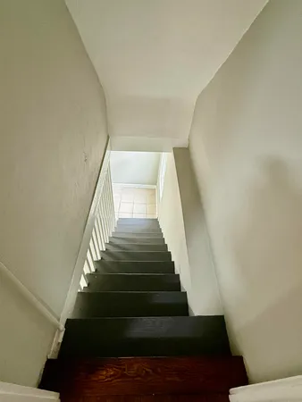 an empty room with a rug