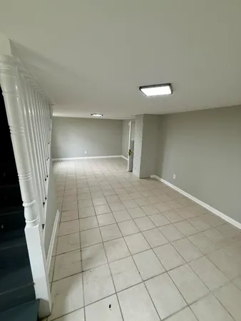 an empty room with a fireplace and cabinet