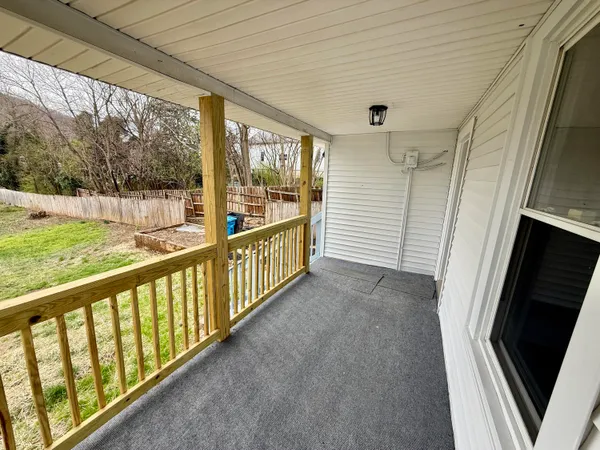 a view of porch with wooden floor
