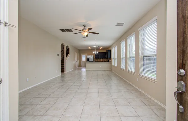 a view of a livingroom with a ceiling fan and window