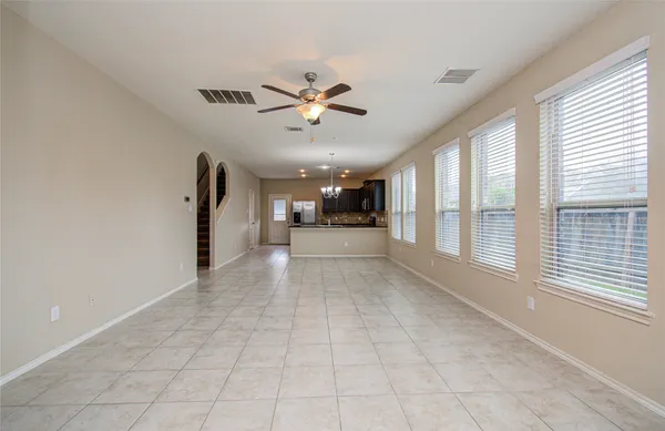 a view of a livingroom with a ceiling fan and window