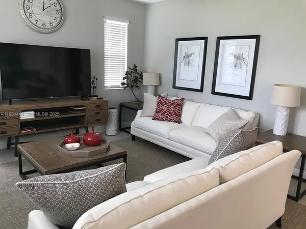 a living room with furniture and a flat screen tv