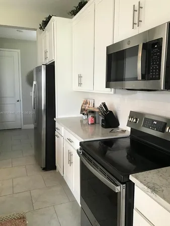 a kitchen with a sink and stainless steel appliances