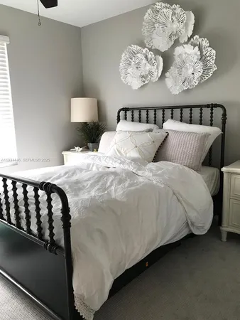 a large bed sitting in a bedroom next to a window