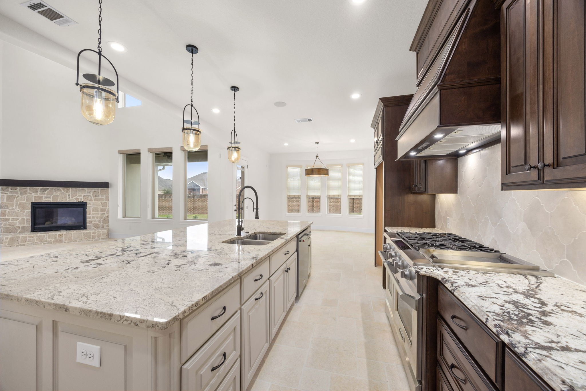 8551 Tombron Grove Road Magnolia, TX 77354 - Photo 15 of 49 The large center island anchors ample prep space and additional seating. Designer lighting and high end finishes elevate the space.
