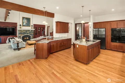 a large kitchen with stainless steel appliances kitchen island granite countertop a large stove a sink and dishwasher