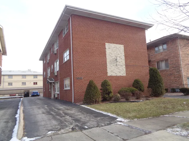 a kitchen with granite countertop a refrigerator and a sink