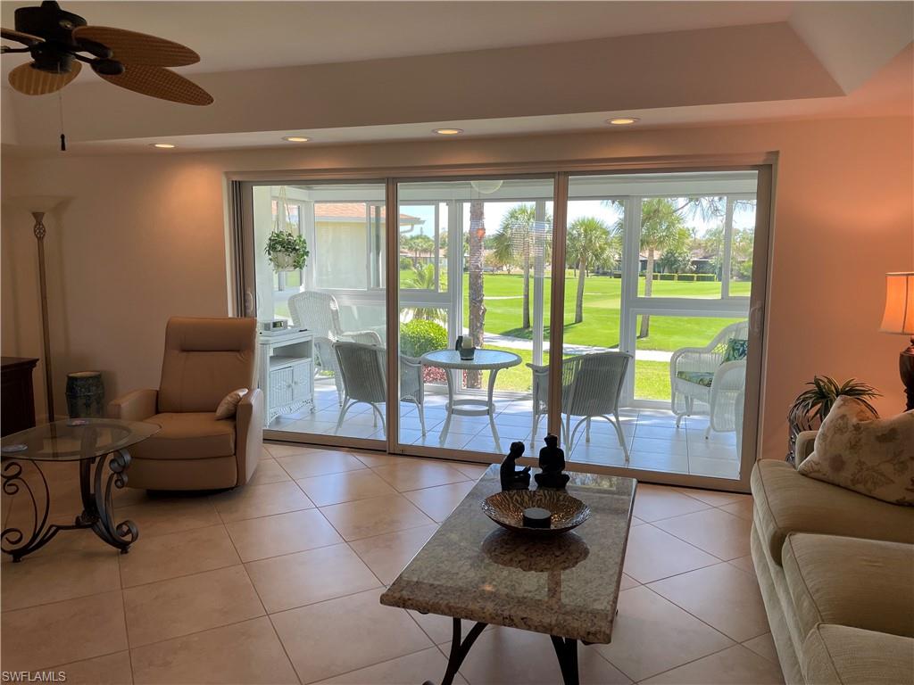 284 Winners Circle, Unit 4 Naples, FL 34112 - Photo 14 of 27 Living area looks out to lanai