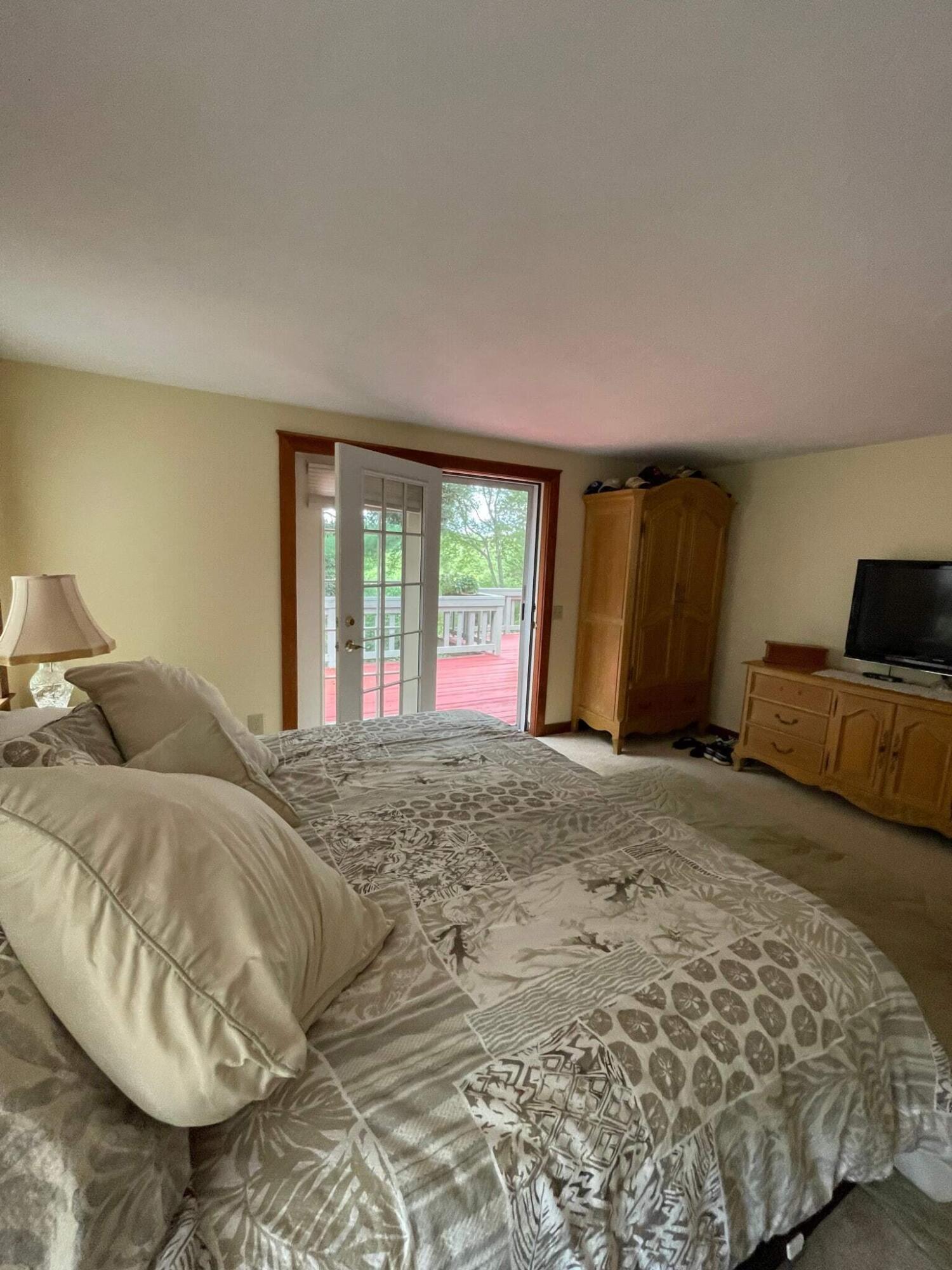 31 Babbling Brook Road Centerville, MA 02632 - Photo 23 of 38 a bed sitting in a bedroom next to a window