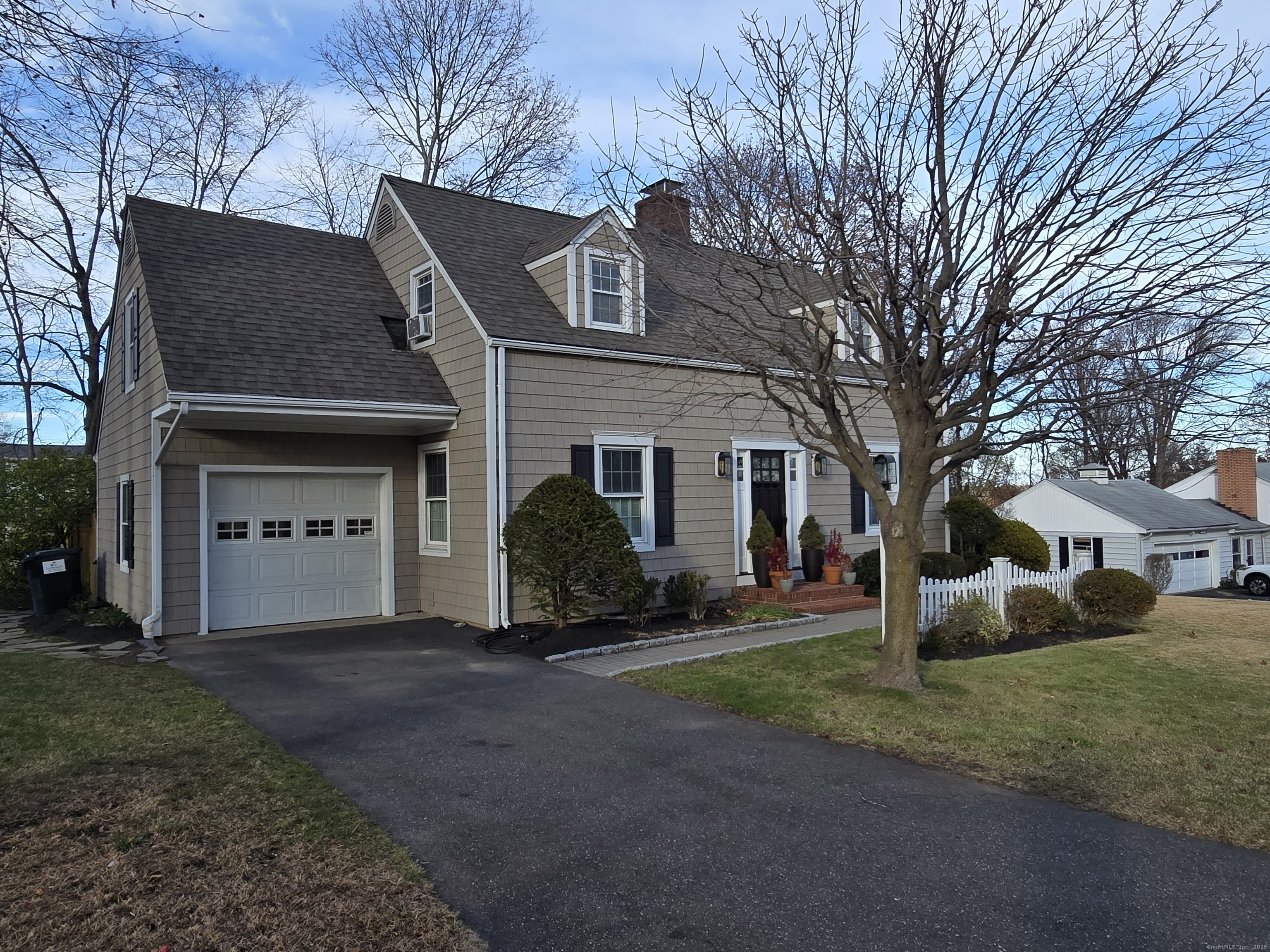 15 Ezra Road Danbury, CT 06811 - Photo 1 of 1 a front view of a house with a yard and garage