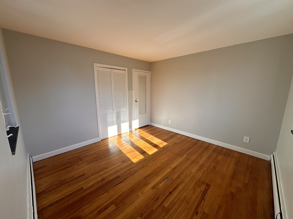 133 Warren Street, Unit 8 Watertown, MA 02472 - Photo 6 of 9 a view of empty room with wooden floor