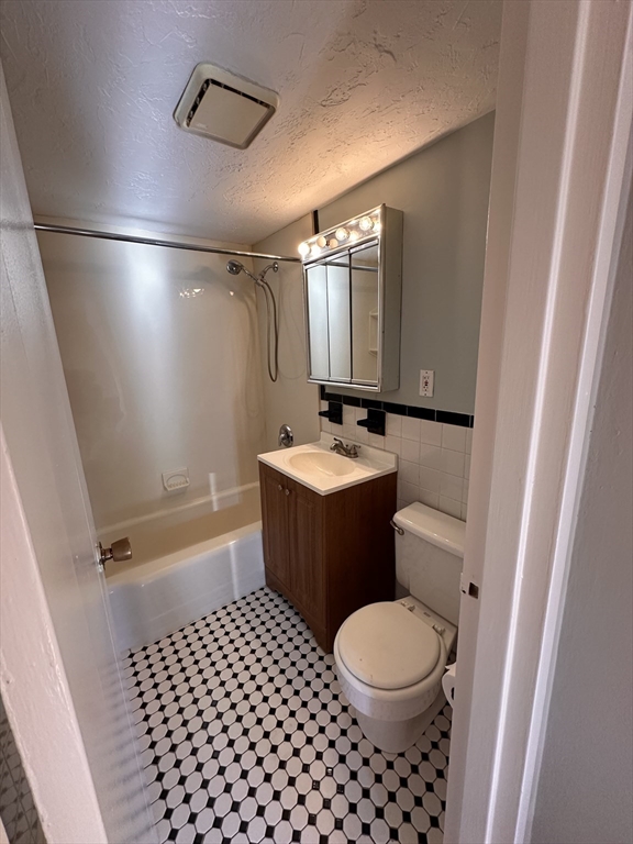 133 Warren Street, Unit 8 Watertown, MA 02472 - Photo 7 of 9 a bathroom with a toilet a sink and a shower