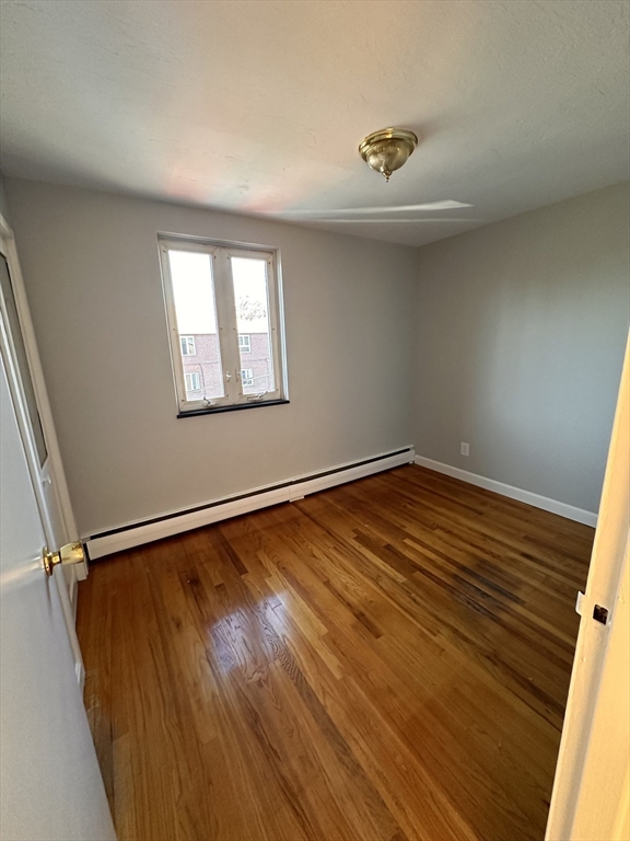 133 Warren Street, Unit 8 Watertown, MA 02472 - Photo 8 of 9 a view of a room with wooden floor and a window