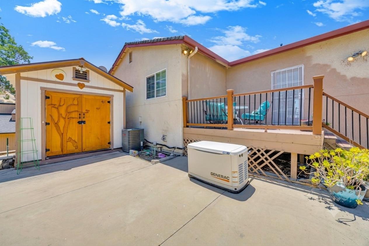 411 Sunrise Road Copperopolis, CA 95228 - Photo 48 of 76 Out back, a large storage shed with amazing custom carved wood door and a Generac add added storage and guaranteed power. The large concrete patio offers endless possibilities.