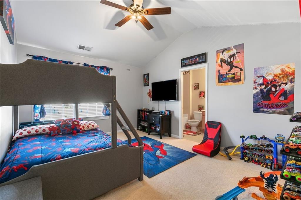 2555 Flat Shoals Road, Unit 5 Atlanta, GA 30349 - Photo 14 of 24 a bedroom with furniture and a flat screen tv