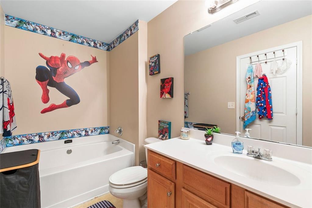 2555 Flat Shoals Road, Unit 5 Atlanta, GA 30349 - Photo 17 of 24 a bathroom with a sink a bath tub and a toilet